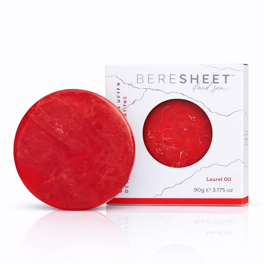 Red soap bar with packaging on a white background