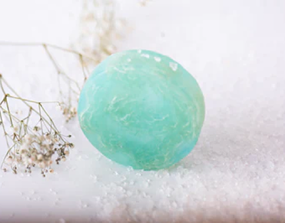 Green soap bar on a white background with small flowers