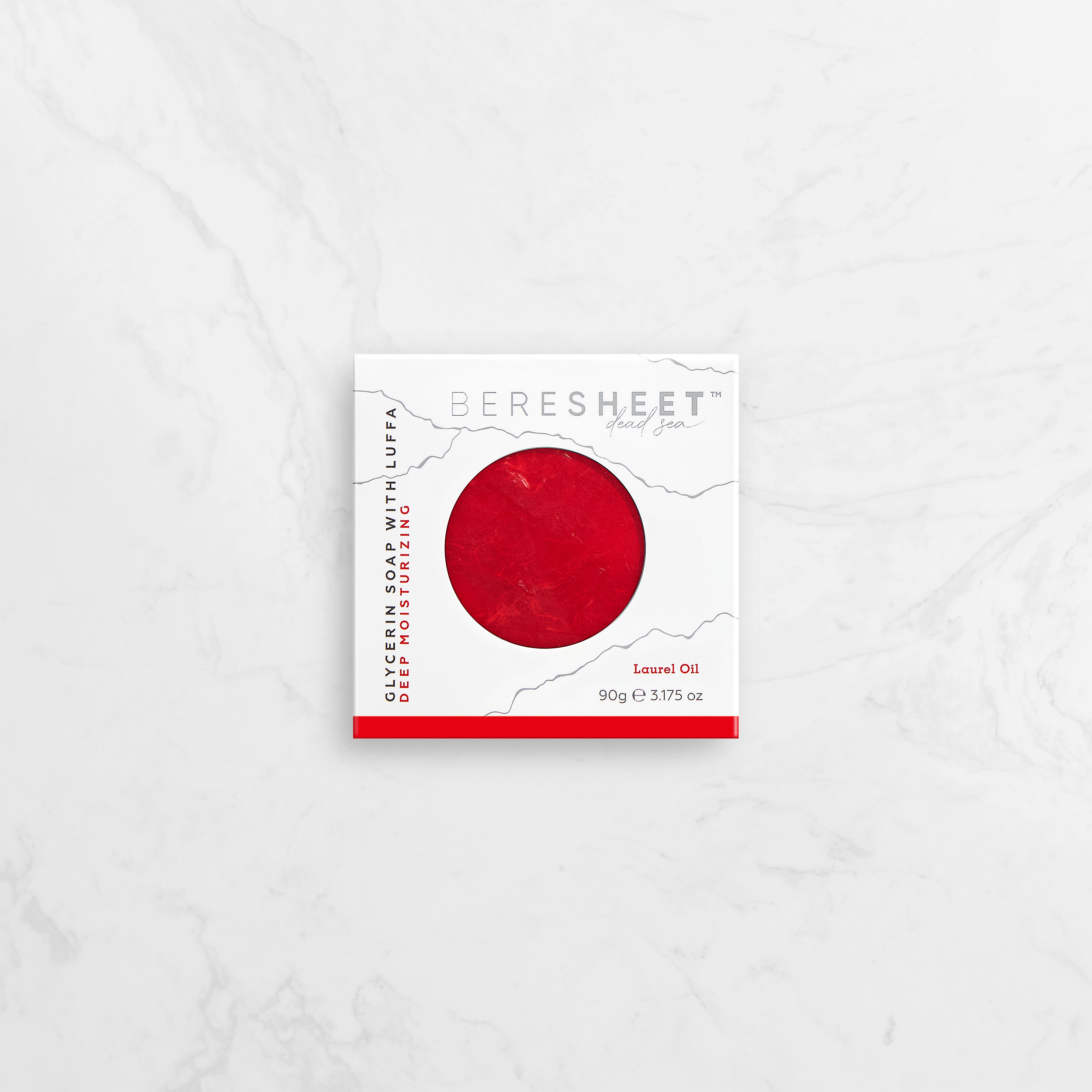Red soap bar with a white label on a light gray background
