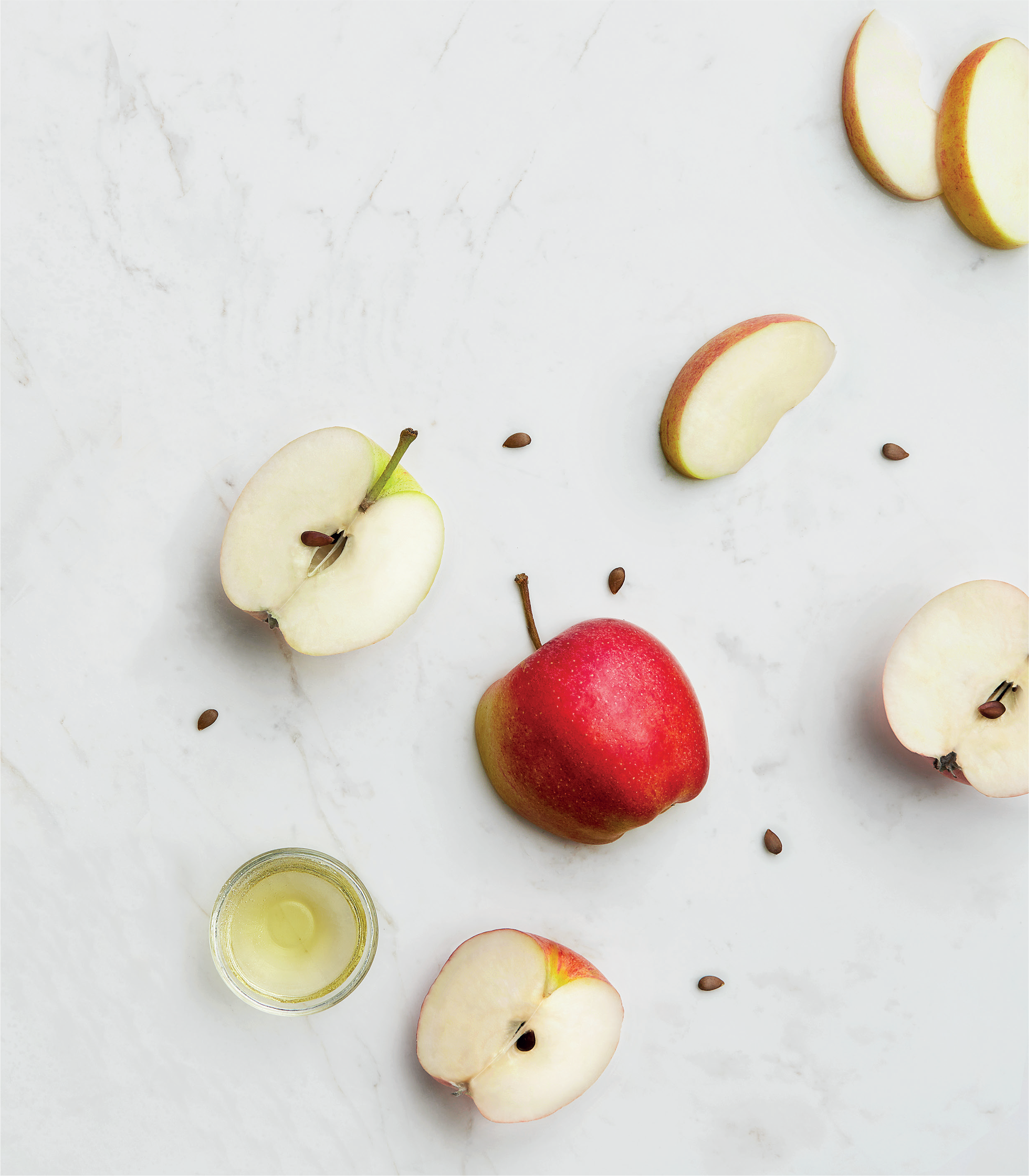 Apples and apple slices on a light gray surface