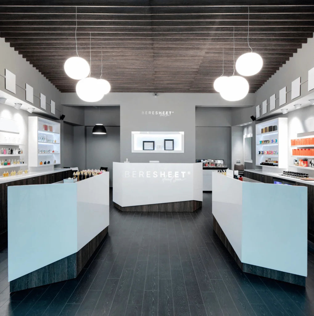 Modern interior of a store with a reception desk and shelves.