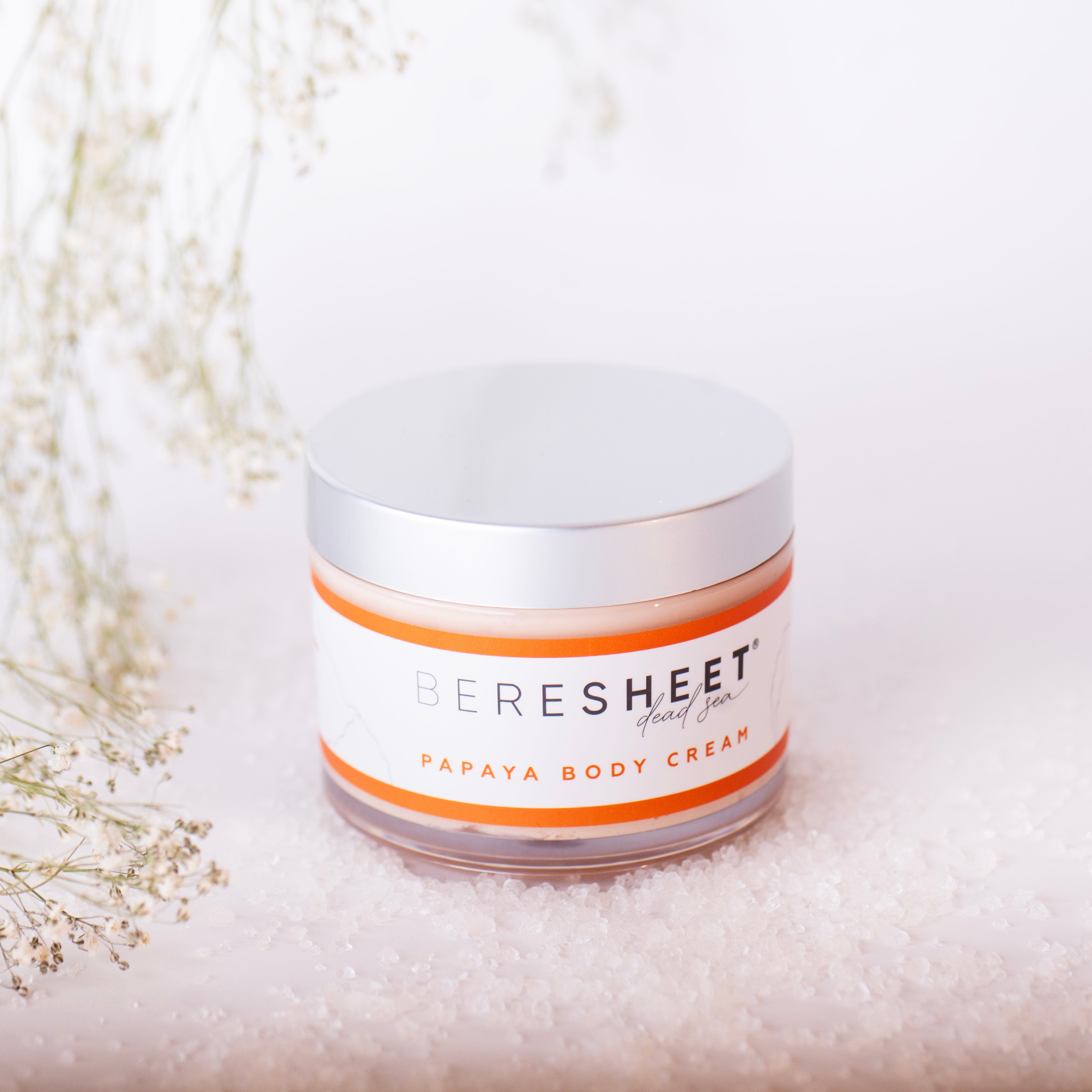 Jar of Ceresheet Papaya Body Cream on a light background with decorative elements