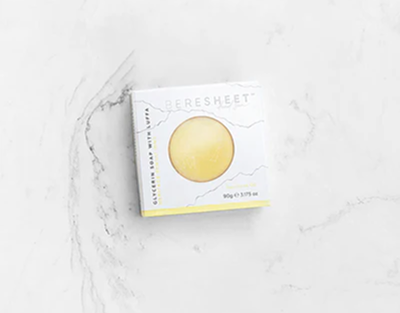 Bar of soap in a white box on a marble surface