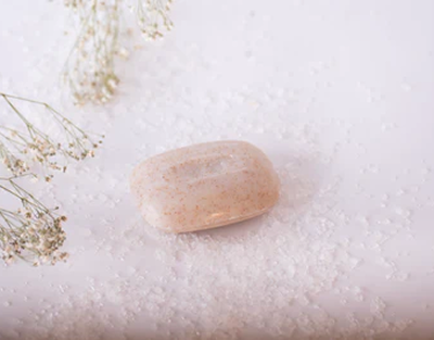Bar of soap on a white surface with small flowers