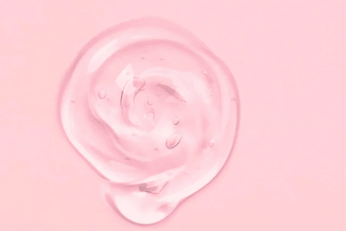 Pink swatch of cream or lotion on a pink background